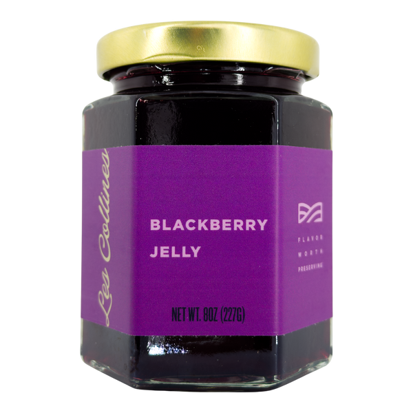 Jar of blackberry jelly with a purple label on a white background