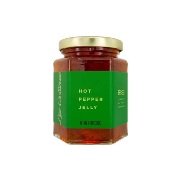 Jar of hot pepper jelly with a green label on a white background