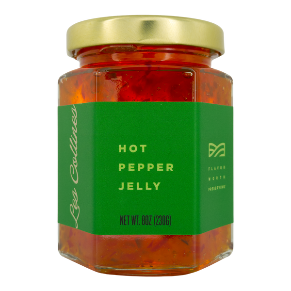 Jar of hot pepper jelly with a green label on a white background