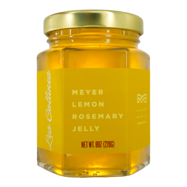 Jar of Meyer Lemon Rosemary Jelly with gold lid on a white background
