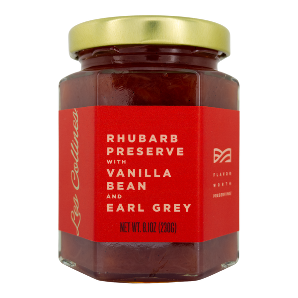 Jar of rhubarb preserve with vanilla bean and earl grey on a white background